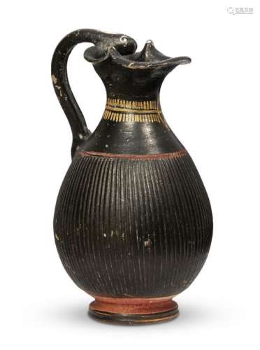 An Etruscan red and black glazed pottery jug with serpent head handle, circa 6th century B.C.,