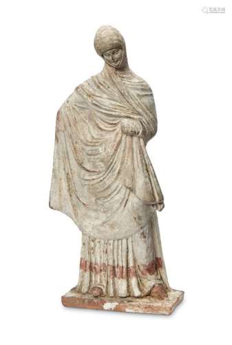 A Greek terracotta figure of a woman, Hellenistic-style, depicted standing on rectangular base,
