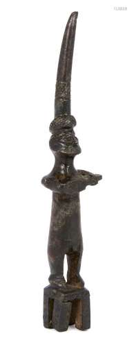 A Hittite bronze figure of a bearded man playing a musical instrument, circa 1500B.C., shown wearing