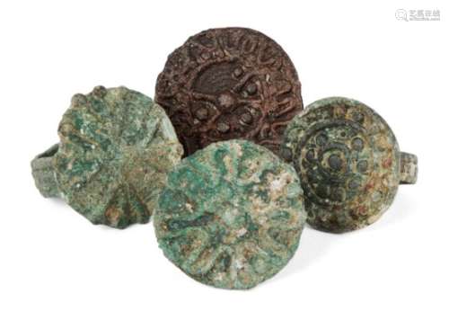A group of four bronze rings, 1st millennium B.C., Caspian Sea, each with flat round bezel with