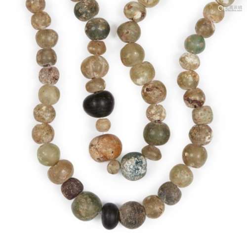 Two Roman glass bead necklaces, 2nd-8th century, comprised of round clear glass beads, one with an