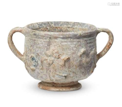 A Roman lead-glazed pottery skyphos with moulded decoration, circa 1st century A.D., with ring