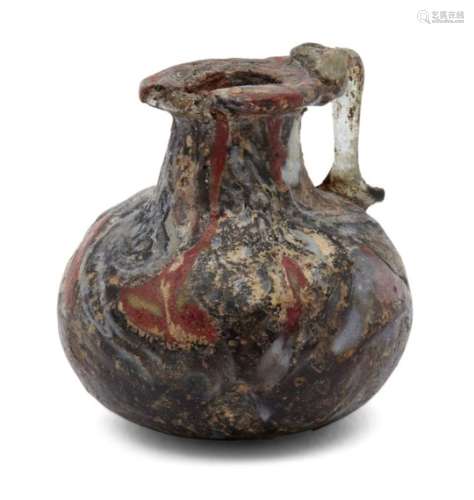 A Roman miniature glass jug, 2nd-4th century A.D., with red and periwinkle coloured streaks on black
