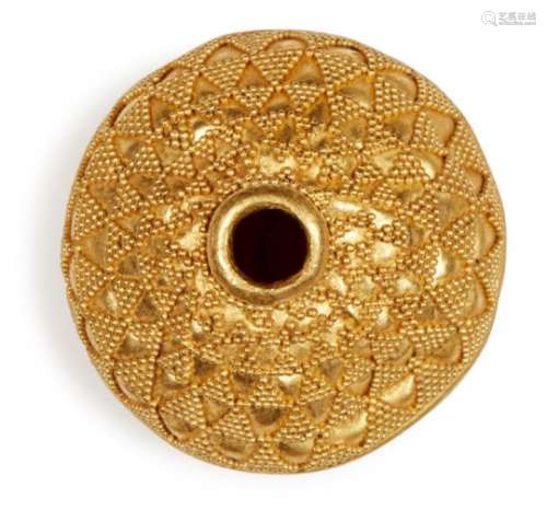 A large gold bead with filigree decoration, of spherical form, decorated in two halves with