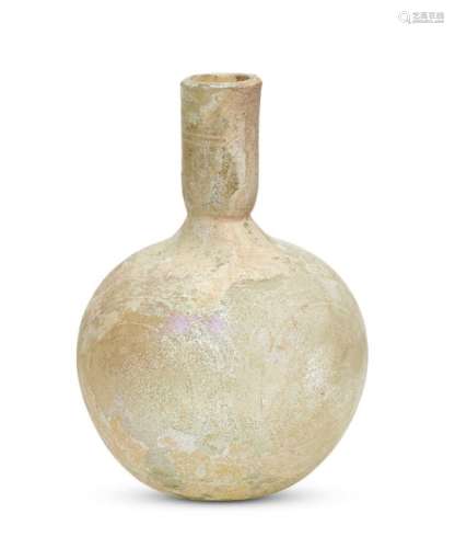 A late Roman pale yellow iridescent glass flask, 4th century A.D., with a cylindrical neck and