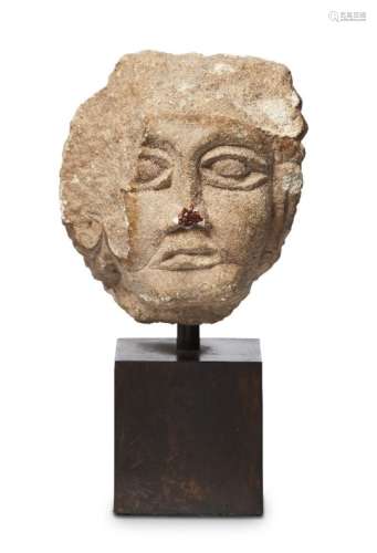 An Eastern Roman carved stone head of a man, 3rd-5th century A.D., with delineated eyes, puffed