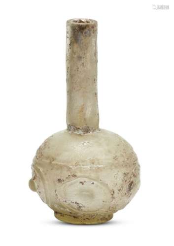 An Islamic yellowish glass flask, Egypt or Syria, 9th-10th century, made in two parts, the lower