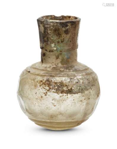 A small Islamic facetted glass bottle, 9th-10th century, the flaring mouth with seven facets and the