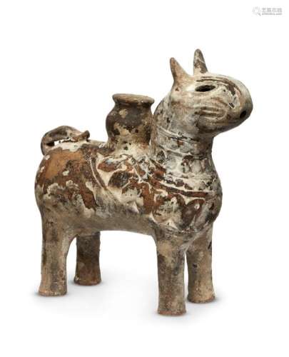 A Seljuk pottery rhyton in the form of a lion, Iran, 13th century, shown standing on four straight