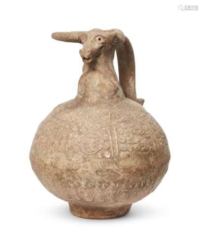 An unglazed pottery jug with ram head spout, Iran, 10th century, of globular form, the body with