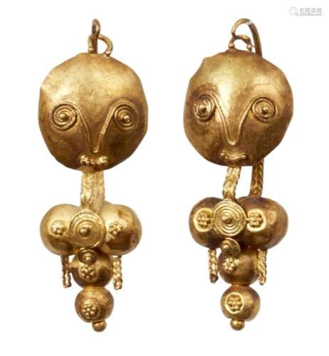 A pair of gold earrings depicting fertility icons, Iran, 10th century, composed of a series of