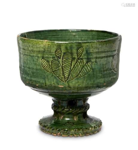 An intact green glazed pottery footed bowl, Iran, 11th-12th century, on a round foot with openwork