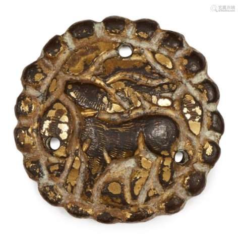 A gilded silver button, Iran, 11th century, the central reserve depicting a deer cast in relief,