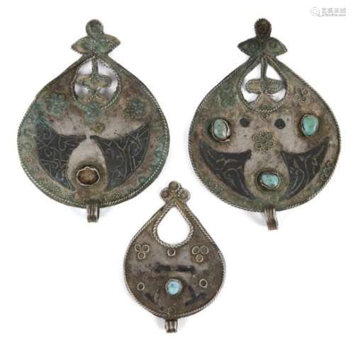 Three Seljuq turquoise-set and nielloed silver pendants, Iran, 12th century, each of drop form