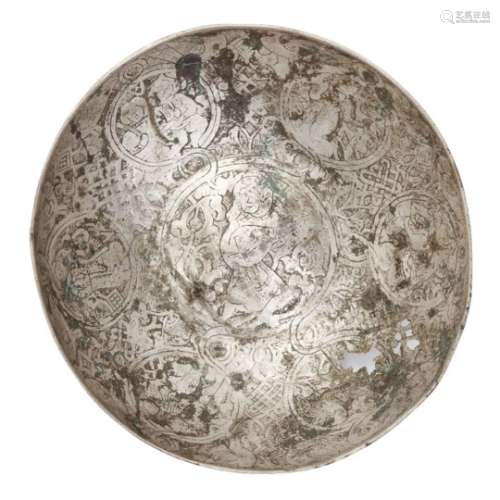 A Seljuq engraved silver bowl, Iran or Syria, 12th century, of deep form with raised central boss,