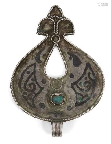 A Seljuq turquoise-set and nielloed silver pendant, Iran, 12th century, of drop form with tri-part