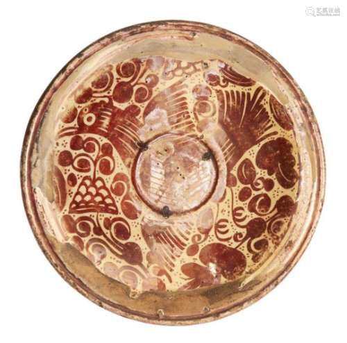 A Hispano-Moresque copper-lustre dish, Spain, 17th century, of shallow form, the centre and well