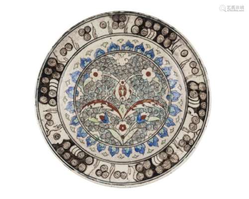 An Iznik-style pottery dish, Kutahya, Turkey, 17th/18th century, of shallow form, underglaze painted