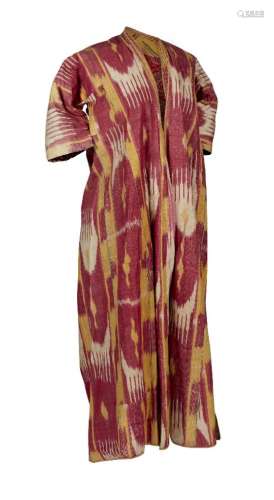 A chapan of silk and cotton ikat, woven in shades of red and ochre with lobed medallions,