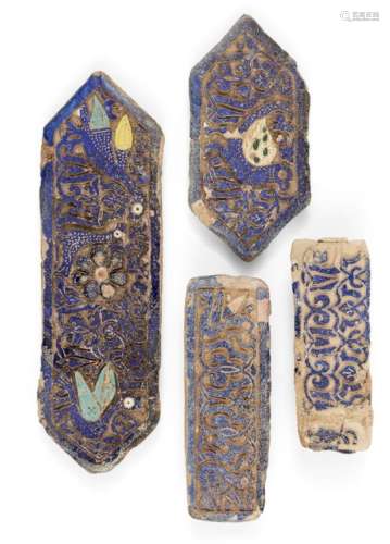 Four deeply carved tiles, Iran, 19th century, the largest of rectangular form with pointed ends, the