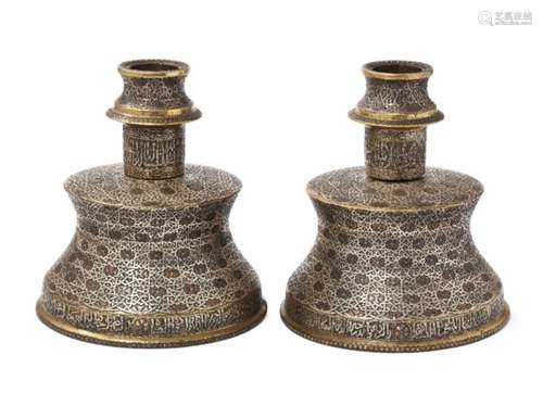 Two large silver- and copper-inlaid brass candlesticks in the Mamluk style, Egypt or Syria, 20th