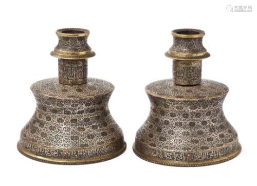 Two large silver- and copper-inlaid brass candlesticks in the Mamluk style, Egypt or Syria, 20th