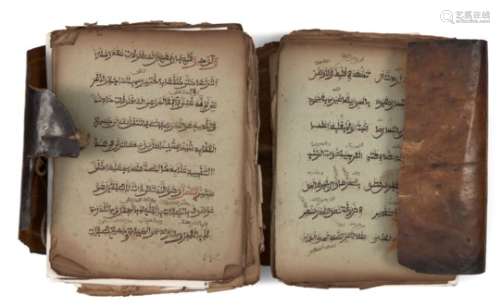 A North African Qur'an in animal skin, 19th century or earlier, unbound, 9ll. of sepia script to the