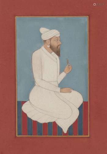 A Pahari nobleman seated on a striped dhurrie, Punjab Plains, circa 1840, gouache on paper,