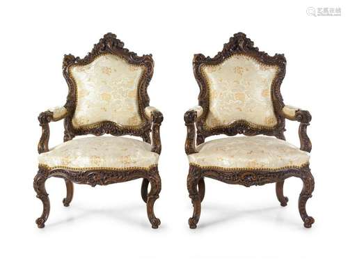 A Pair of Rococo Revival Carved Walnut Fauteuils