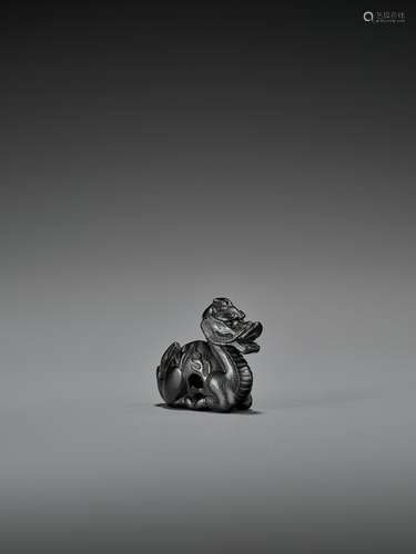 A RARE EBONY WOOD NETSUKE OF A KIRIN AS A DUCK