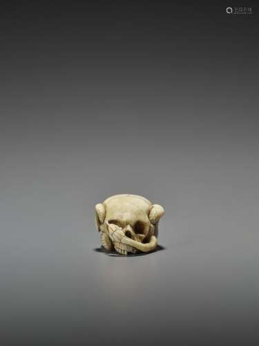 STAG ANTLER NETSUKE OF A SKULL WITH SNAKES