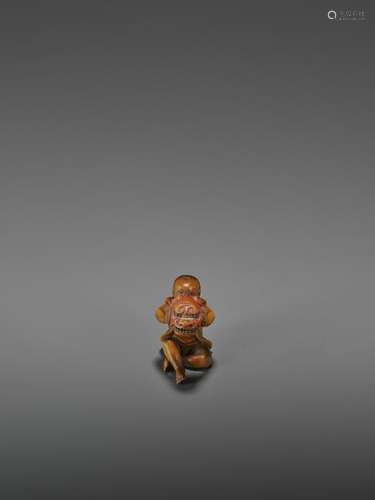 A LACQUERED WOOD NETSUKE OF A BOY