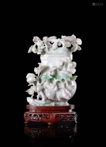 A jadeite vase, carved with flowering branches, the stone with apple-green veins, wood baseChina,