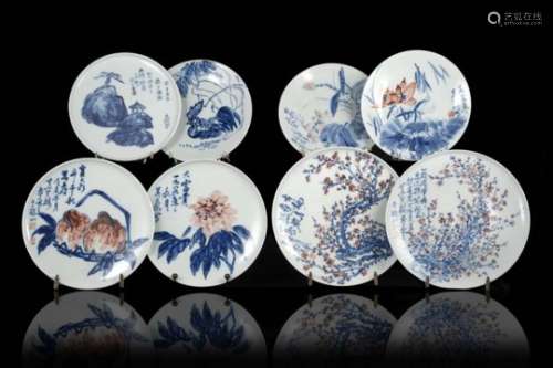 A group of eight blue, white and red porcelain dishes decorated with floral motifs and