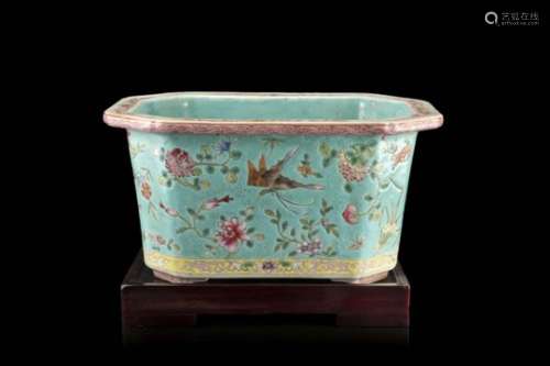 A turquoise-ground Famille Rose octagonal jardiniere decorated with butterflies and flowers, wood