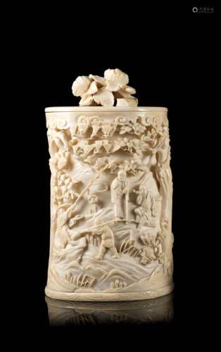 An ivory cylindrical box and cover carved and pierced with a landscape scene and floral motifsJapan,