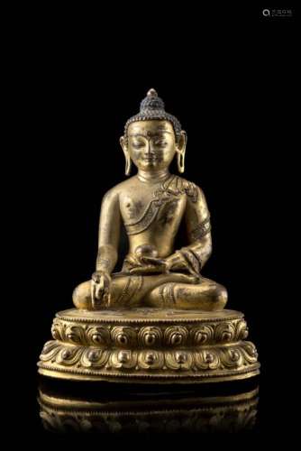 A gilt-bronze figure of the medicine Buddha, Bhaishajyaguru, seated in dhyanasana on a double-