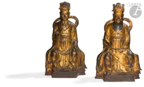 CHINE - XIXe siècle Deux statuettes de dignitaires en bronze à traces de laque or et rouge, assis,