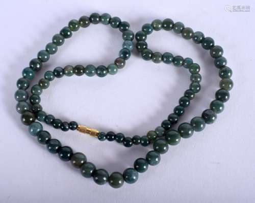 A CHINESE CARVED JADEITE NECKLACE. 58 cm long.