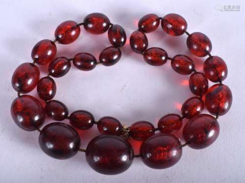 A CHERRY AMBER NECKLACE. 44 cm long.