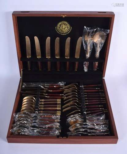 A STYLISH BRASS AND HARDWOOD CANTEEN OF CUTLERY.