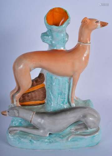 A STAFFORDSHIRE POTTERY GROUP OF TWO GREYHOUNDS,