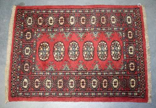 AN EARLY 20TH CENTURY RED GROUND TEKKE TURKMEN PRAYER