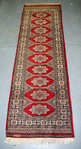 AN EARLY 20TH CENTURY TEKKE TURKMEN RUNNER RUG,