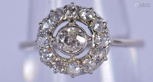 AN EDWARDIAN PLATINUM AND DIAMOND CLUSTER RING of