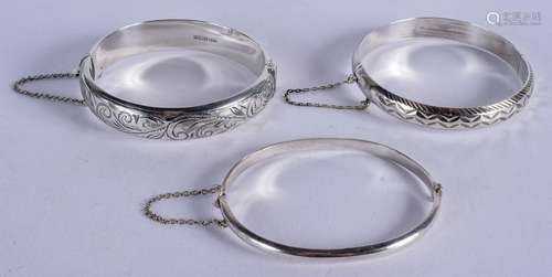 THREE SILVER BANGLES. 6.5 cm wide. (3)