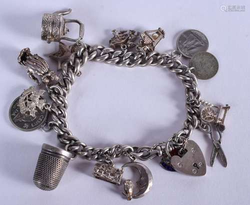 A VINTAGE SILVER CHARM BRACELET with mostly silver