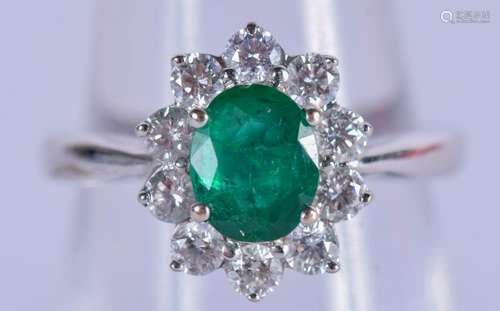 A 9CT GOLD EMERALD AND DIAMOND CLUSTER RING. Size J.