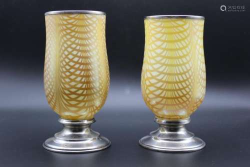 A pair of glass with sterling silver candleholders