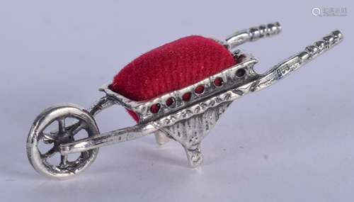 A SILVER WHEELBARROW PIN CUSHION. 5 cm wide.